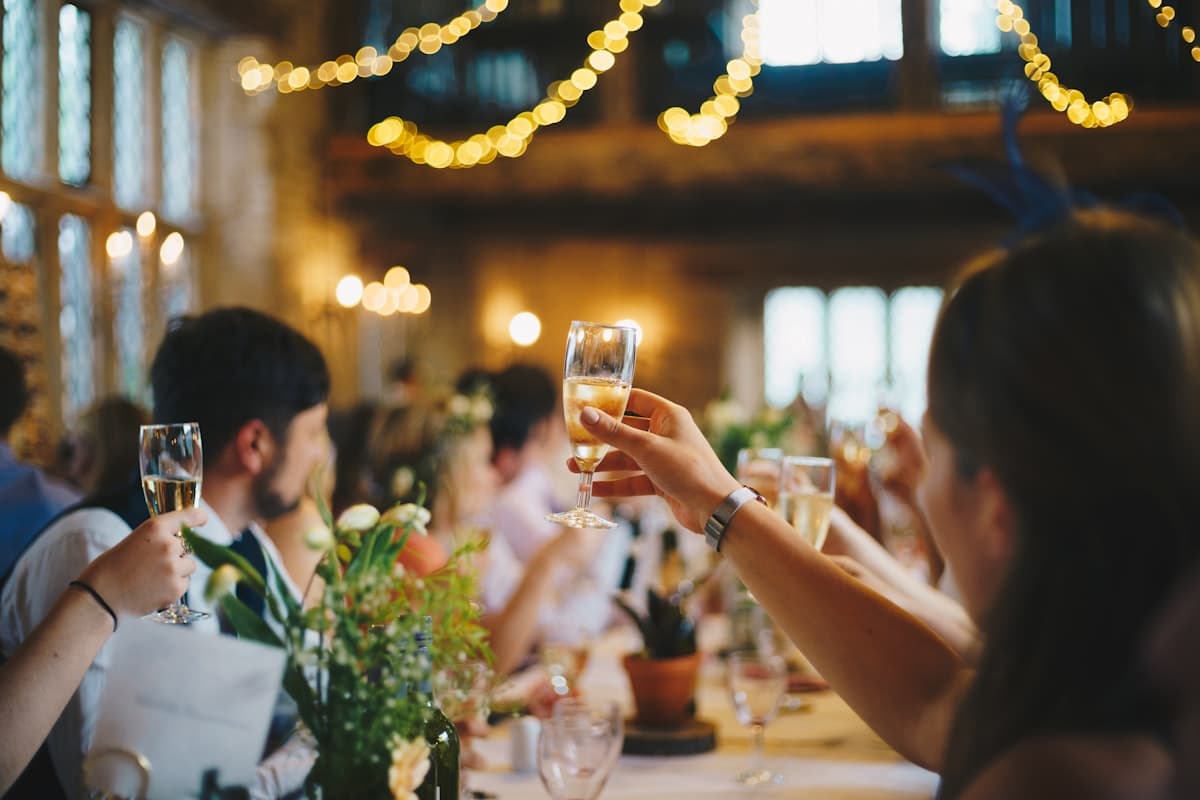 Wedding guests raising glasses for a toast