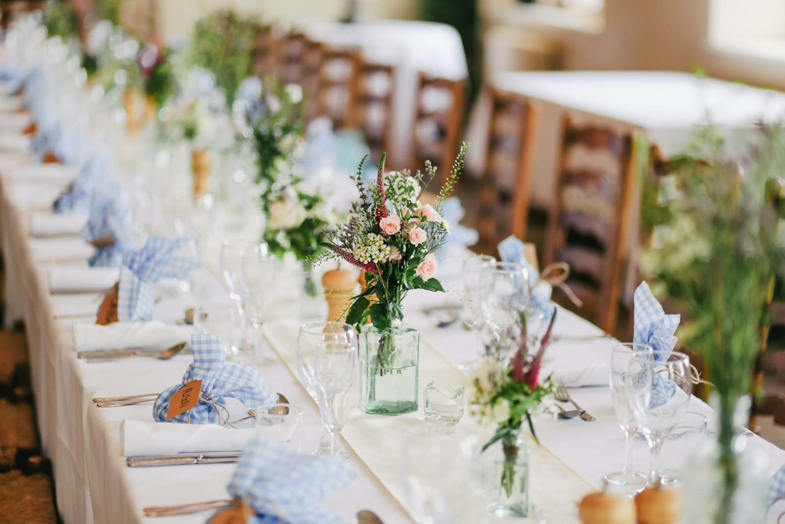 A couple at their wedding reception while guests film on their phones.